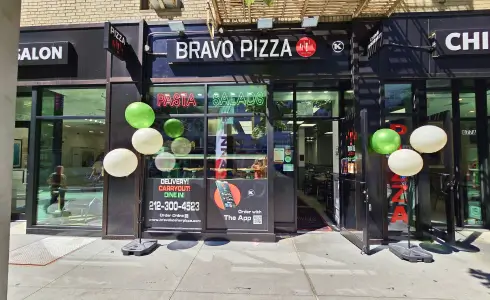 arafed view of a pizza restaurant with balloons and a sign