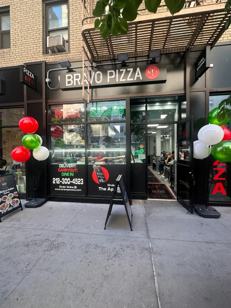 arafed pizza shop with balloons and a sign for a pizza restaurant