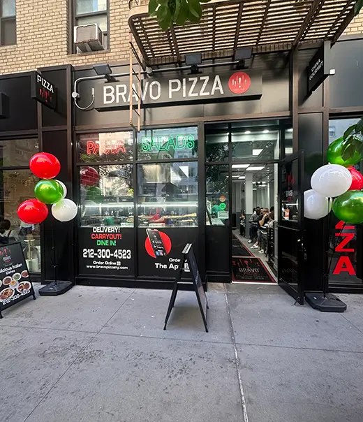 arafed pizza restaurant with balloons and a sign for a pizza place