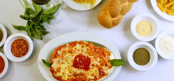 a close up of a pizza on a plate with sauces and bread