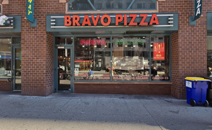 arafed brick building with a sign that says bravo pizza