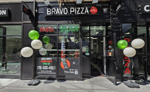 arafed view of a pizza restaurant with balloons and signs